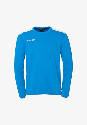 Langærmet træningsskjorte i lys blå stof med hvide skulderdetaljer. Har en rund halsudskæring og "Kempa"-logoet i hvid.