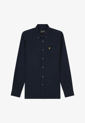 Camisa de manga larga azul marino, hecha de algodón, con cuello abotonado, que cuenta con un bolsillo en el pecho y un logo de águila bordado en amarillo.