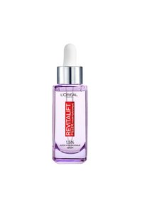 Flacon de sérum en verre violet avec un compte-gouttes blanc, muni d'un capuchon argenté et d'une étiquette avec un texte rouge indiquant "Revitalift Filler" et "1,5% Acide Hyaluronique."