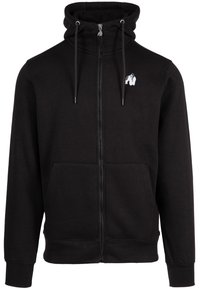 Zwarte zip-up hoodie met een hoge kraag, trekkoorden, kangoeroezakken en een klein wit dierenlogo op de borst. Zacht materiaal, geribbelde manchetten.