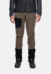 Beige buitenbroeken met zwarte, gestructureerde zakken, elastische boorden en versterkte knieën. Glad stof met waterafstotende eigenschappen.