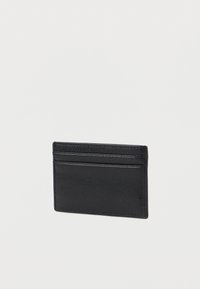 Black leather cardholder with a textured finish, featuring four card slots and a slim design. No visible logos or hardware accents.
