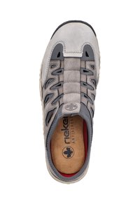 Gray suede shoe with a rounded toe, elastic lace design, cutouts on sides, and textured rubber sole. Features cork insole and red accents.