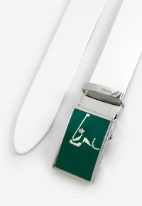 White leather belt with a silver metal buckle. The buckle features a green square design with a white silhouette of a golfer in action.