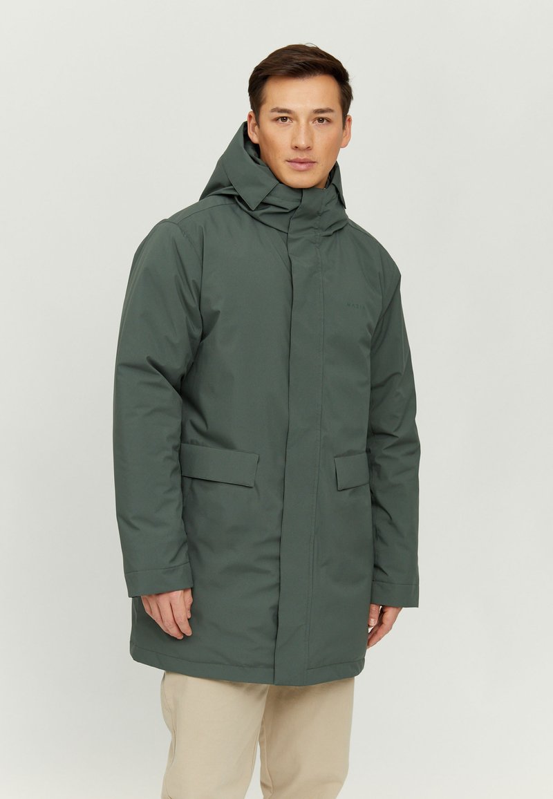 Green waterproof parka with a high collar and adjustable hood. Features two front pockets and a straight cut. Smooth texture and minimalist design.