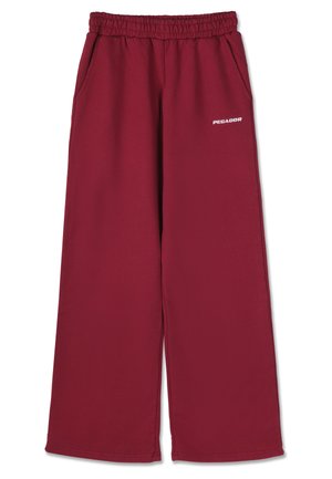 Καμπάνα σκούρου κόκκινου χρώματος με ελαστική μέση, πλευρικές τσέπες και κεντημένο το λογότυπο "PEGADOR" σε λευκό κοντά στη μέση.