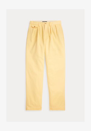 Heledad kollast puuvillasest riidest püksid, mis on lõdva istuvusega, esiosal plisseeritud, vööaasadega ja ühe nööpidega suletava ees taskuga.