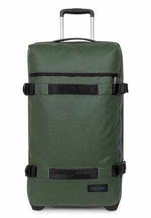 Green upright rolling suitcase with telescoping handle, black compression straps, and Eastpak logo on front lower corner.