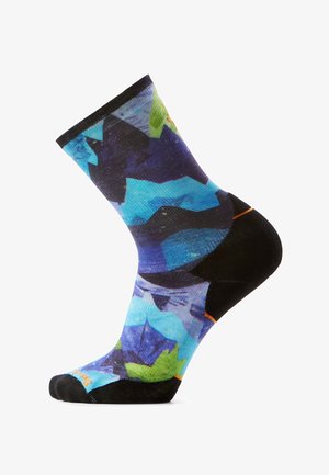 Skarpeta z czarnym obcasem, palcem i mankietem, ozdobiona wielokolorowym abstrakcyjnym wzorem w tonacjach niebieskiego, zielonego i fioletowego.