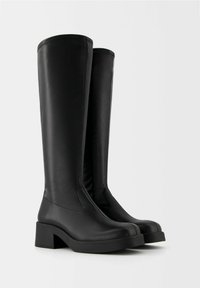 Black knee-high boots made of smooth synthetic leather, featuring a chunky heel, rounded toe, and minimal stitching.
