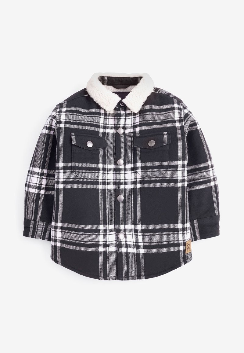 Chemise à carreaux noir et blanc avec col en sherpa, manches longues, devant boutonné, et deux poches poitrine. Tissu doux et texturé.