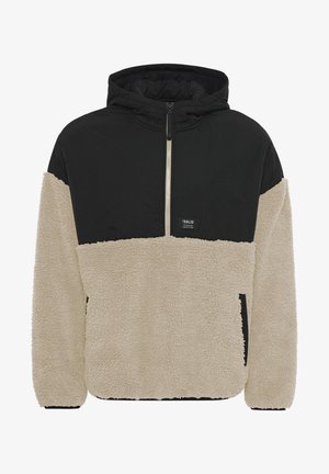 Capuchon pulloverjack met een zwarte nylon bovenkant en een beige fleece onderkant. Heeft een centrale ritssluiting en zijzakken; textuurstof.