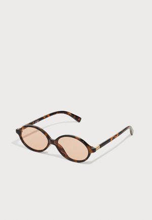 Sunglasses with tortoiseshell frame, oval shape, pink lenses, gold accent on temple, smooth finish, and curved arms.