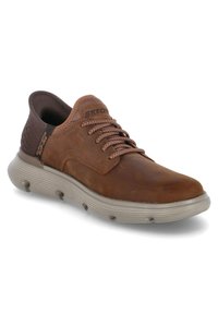 Scarpa in pelle marrone con dettagli testurizzati, lacci marroni e suola grigia chiara con un motivo a scanalature per una migliore aderenza. Logo "Skechers" sul lato.