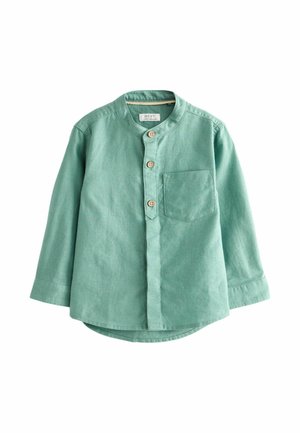 Chemise vert menthe à manches longues avec col montant, trois boutons en bois sur le devant, poche poitrine et ourlet arrondi.