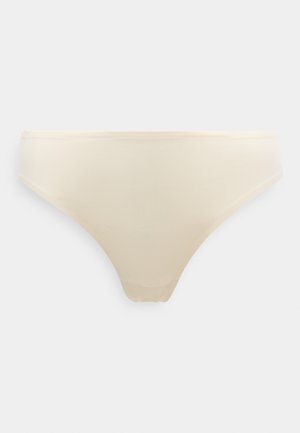 Beżowa bielizna w stylu bikini bez szwów, z gładkim pasem i minimalną liczbą szwów, zaprojektowana dla komfortu i niemal niewyczuwalnego noszenia.