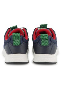 Baskets de sport bleu marine avec doublure textile rouge, languettes à motif vert et semelles blanches. Présentent une finition texturée et un détail perforé.
