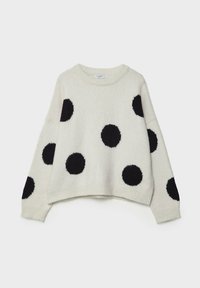 Pull en maille crème avec grands pois noirs, col rond, épaules tombantes et ourlet et poignets côtelés. Texture douce et coupe ample.