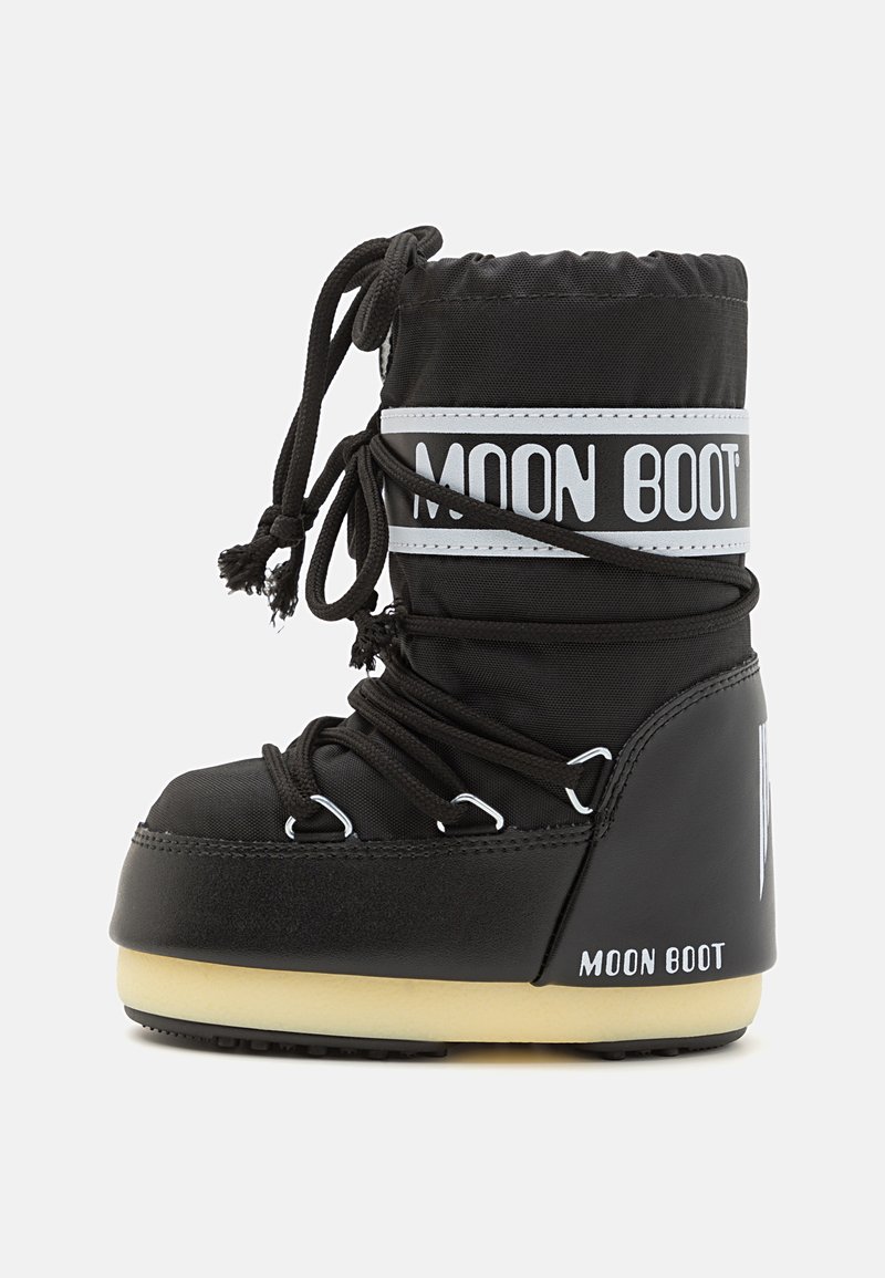 Black waterproof boot with a padded nylon upper, lace-up design, white branding on the cuff, and a thick beige sole. Textured finish.
