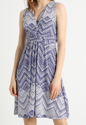 Sleeveless V-neck dress with blue and white geometric patterns, fitted waist, and pleated skirt, worn by a person standing against a plain background.