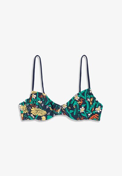Haut de bikini à imprimé floral avec des fleurs vertes, jaunes, orange et blanches sur un fond bleu foncé et des bretelles fines bleu foncé.