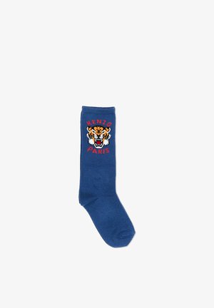 Chaussette bleue présentant un design de tête de tigre rugissante avec le texte "KENZO PARIS" au-dessus et en dessous du graphisme.