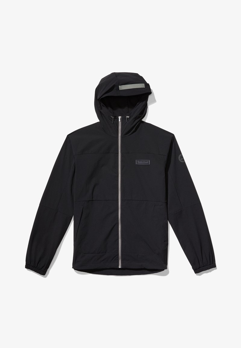 Musta takki hupparilla, jossa on vetoketjullinen etuosa, elastiset hihansuut ja heijastinraita hupussa; sileä kangas, minimalistinen muotoilu.