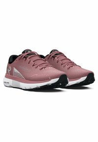 Pink athletic shoes with a textured mesh upper, black accents, and white midsole. Features intricate perforations for breathability and traction.