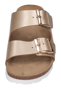 Gold leather slide sandal with two adjustable straps, metallic buckles, and a cork footbed. The outsole is white and textured.