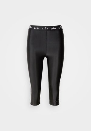 Sorte croppe leggings med glansfull overflate, med bred midjebånd merket "crās" og en glatt tekstur. Ingen synlige sømmer eller mønstre.