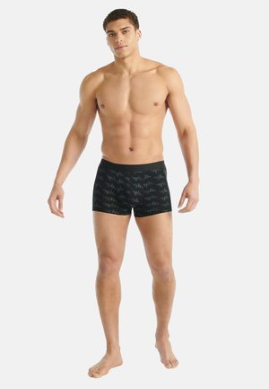 Svarta badbyxor med ett geometriskt mönster, tillverkade av stretchigt material. Har en enfärgad svart midjeresår, designad för en atletisk passform.