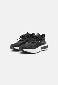 Black athletic sneakers featuring a textured upper, sturdy laces, a cushioned white midsole, and a rubber outsole for traction.