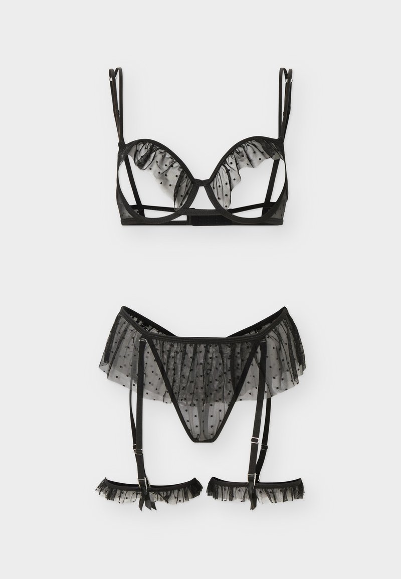 Σετ μαύρο διάφανο εσώρουχο με πουά διαφάνεια, που περιλαμβάνει σουτιέν με μπανέλα, ζώνη ζαρτιέρα με βολάν, τόνγκα που ταιριάζει και ζώνες για τα πόδια.