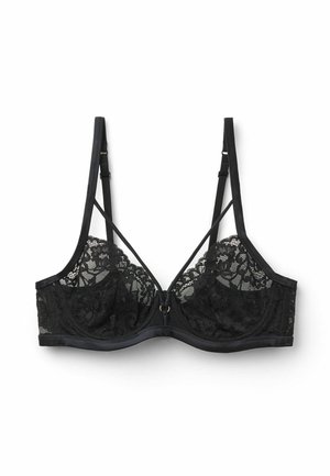 Sujeción con aro de encaje negro con tirantes ajustables y tirantes decorativos delanteros sobre un fondo blanco.