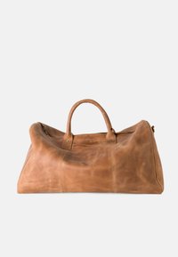 Leather duffel bag in tan, featuring two sturdy handles, top zipper closure, and smooth texture with visible seams and stitching details.