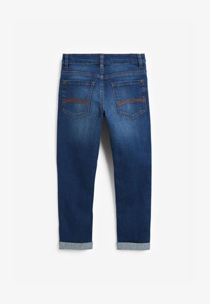 Tumši zilas džinsa bikses ar oranžu šuvi, divām aizmugurējām kabatām ar dekoratīvu šuvi, jostas cilpām un uzlocītiem galiem.