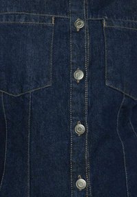 Donkerblauwe denim shirt met zilveren drukknoopjes, borstzakken en zichtbare stiksels. Gladde textuur met een getailleerd ontwerp.