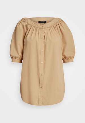 Beige, olkapäistä paljastava paita, jossa on puffi lyhyt hiha, edessä napitus ja rypytetty kaula-aukko. Valmistettu kevyestä kankaasta, jossa on sileä rakenne.