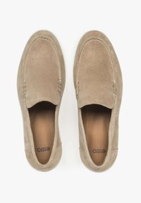 Beige suede slip-on shoes with a rounded toe, decorative stitching, and a white rubber sole. Interior features a smooth, lighter leather lining.