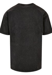 Black short-sleeve t-shirt made of cotton with a slightly washed look. Features a round neckline and visible stitching details.