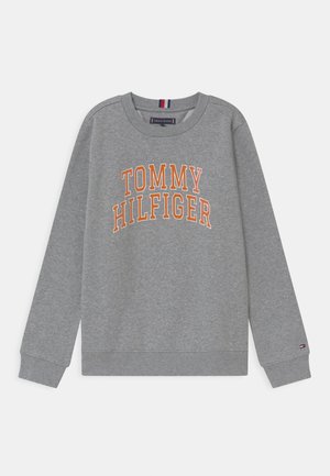 Sudadera gris hecha de una mezcla de algodón, con el logotipo "TOMMY HILFIGER" en naranja atravesando el pecho, y con puños y dobladillo acanalados.