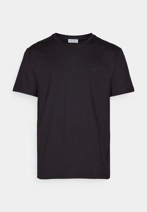 Black short-sleeve T-shirt made of smooth cotton, featuring a round neckline and a subtle logo tag on the chest. Plain and simple design.