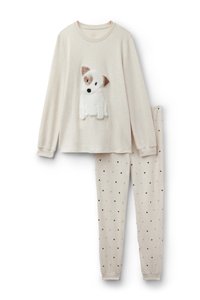 Beżowa bluzka z długim rękawem z aplikacją pluszowego psa; dopasowane legginsy z małymi czarnymi serduszkami na jasnym tle. Miękka tkanina na całej powierzchni.