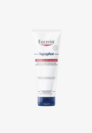 Eucerin Aquaphor Tube, weiß mit blauen Akzenten, das "Schützen & Reparieren" in rotem Text zeigt. Entwickelt für trockene, gereizte Haut. 100 ml.
