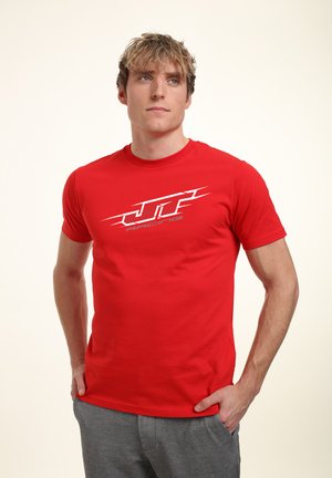 Red short-sleeved t-shirt made of cotton with a silver "JTF Racing" logo on the front, showcasing a fitted design and crew neck.
