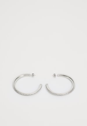 Silver hoop earrings with a textured design along one edge, featuring a smooth surface and a post-back closure.
