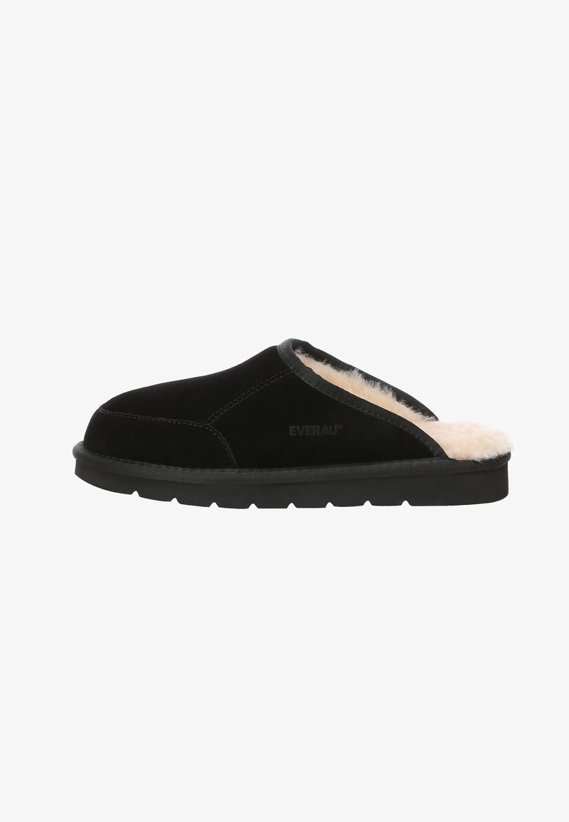 Black suede slip-on slipper with soft beige fur lining, textured exterior, and durable black rubber sole featuring a slight contour.