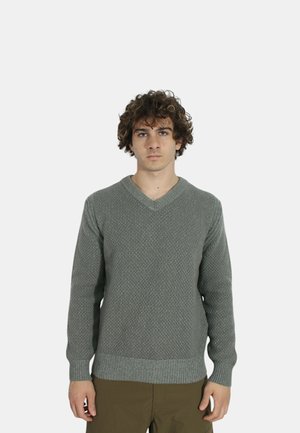 Pullover all'uncinetto di un verde chiaro con scollo a V, motivo tessuto, polsini e orlo a costine, e un taglio rilassato.