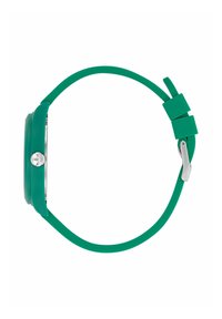 Orologio verde in silicone con cassa rotonda, dettagli in argento e finitura liscia opaca sul cinturino. La vista laterale mette in mostra il design minimalista.
