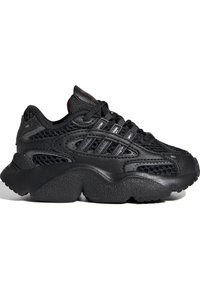 Black athletic shoe with a mesh upper, textured rubber sole, and layered design. Features prominent lacing and side stripes.